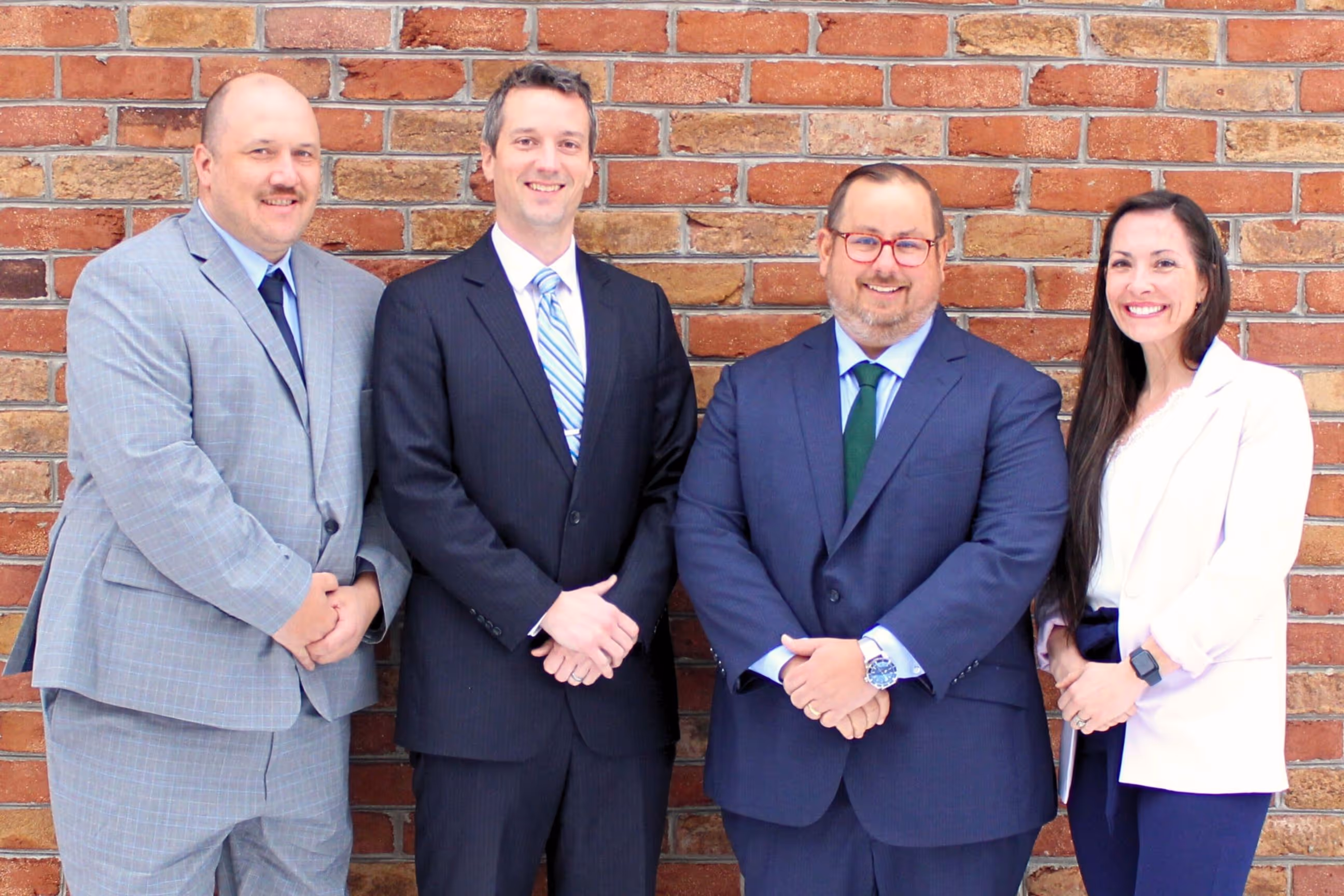 The four members of the Journey Search Partners leadership team standing beside each other