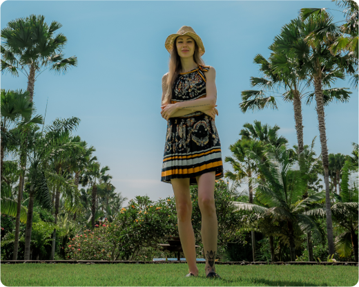 Sarah Marks standing on grass surrounded by trees