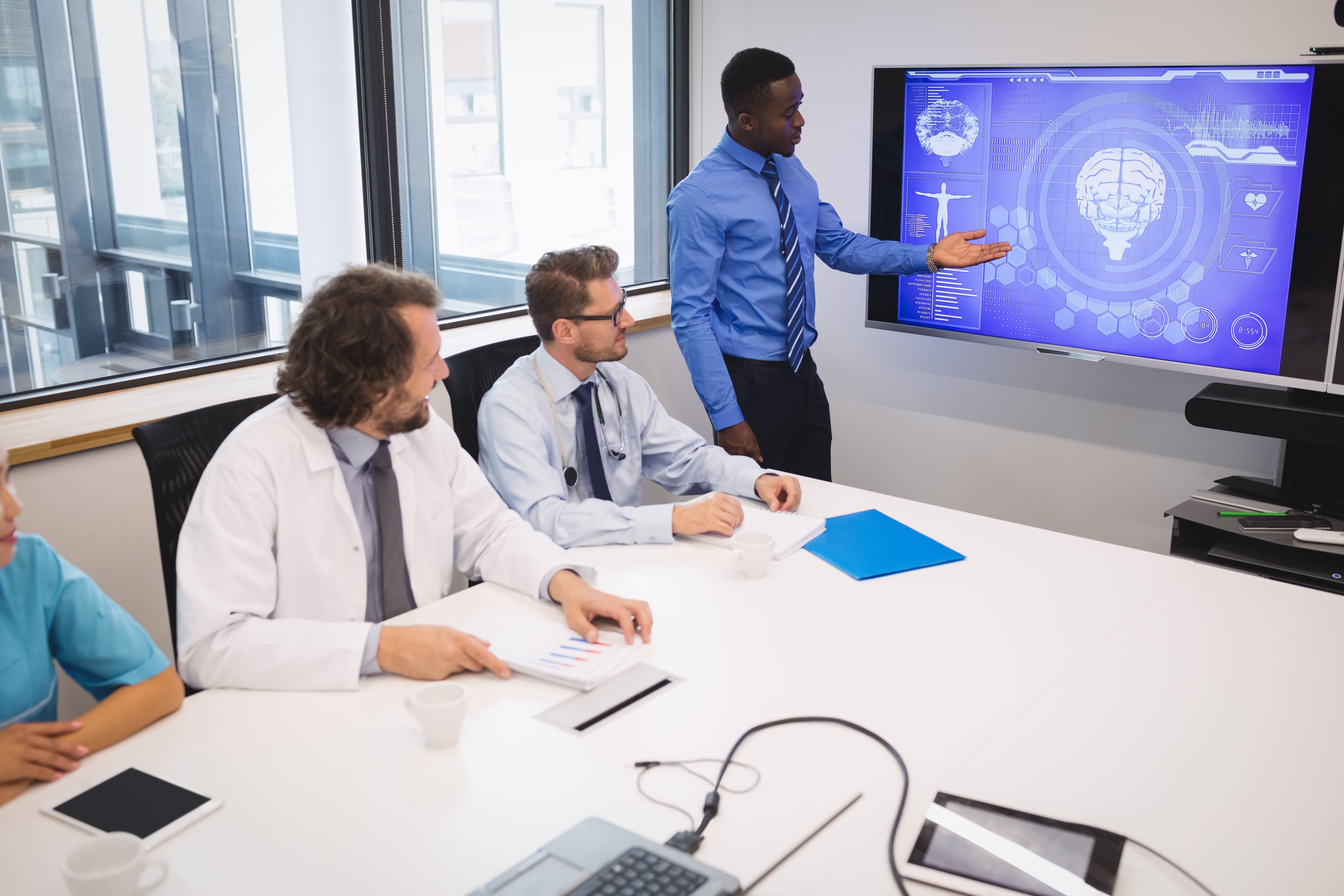 A board room full of doctors going over new medical techniques and learning.