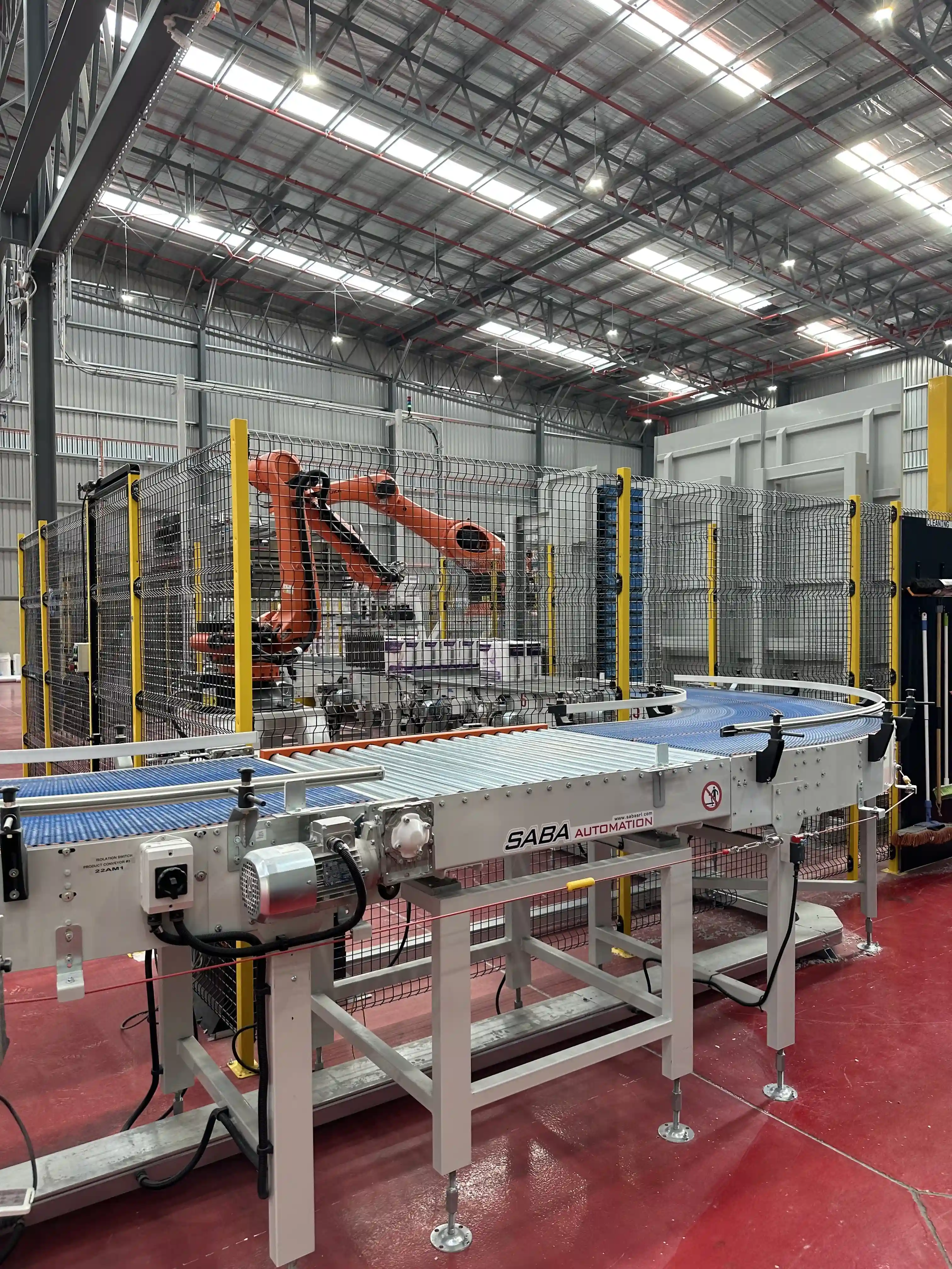 An image of a robot and conveyer in a paper factory