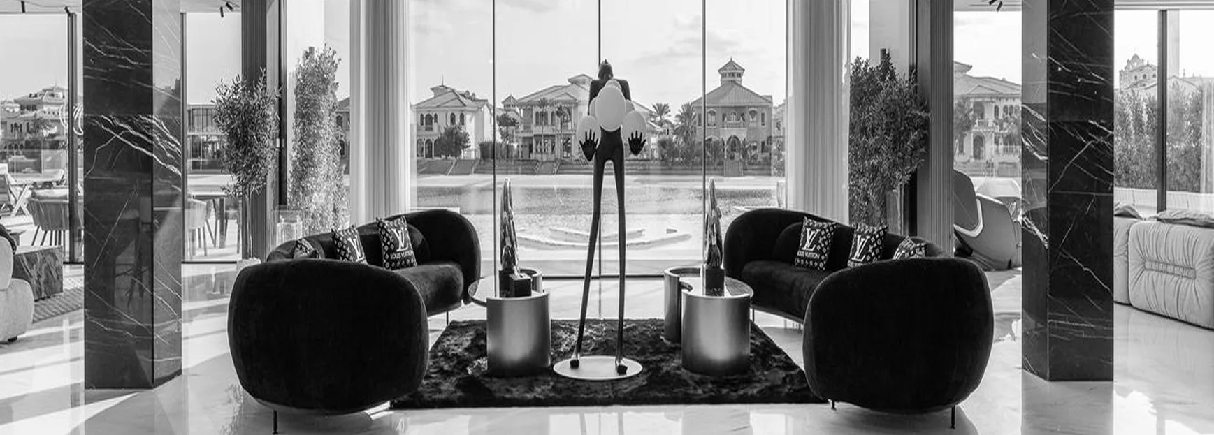 High-end interior fit-out of a luxury villa in Dubai featuring sleek black marble columns, modern furniture