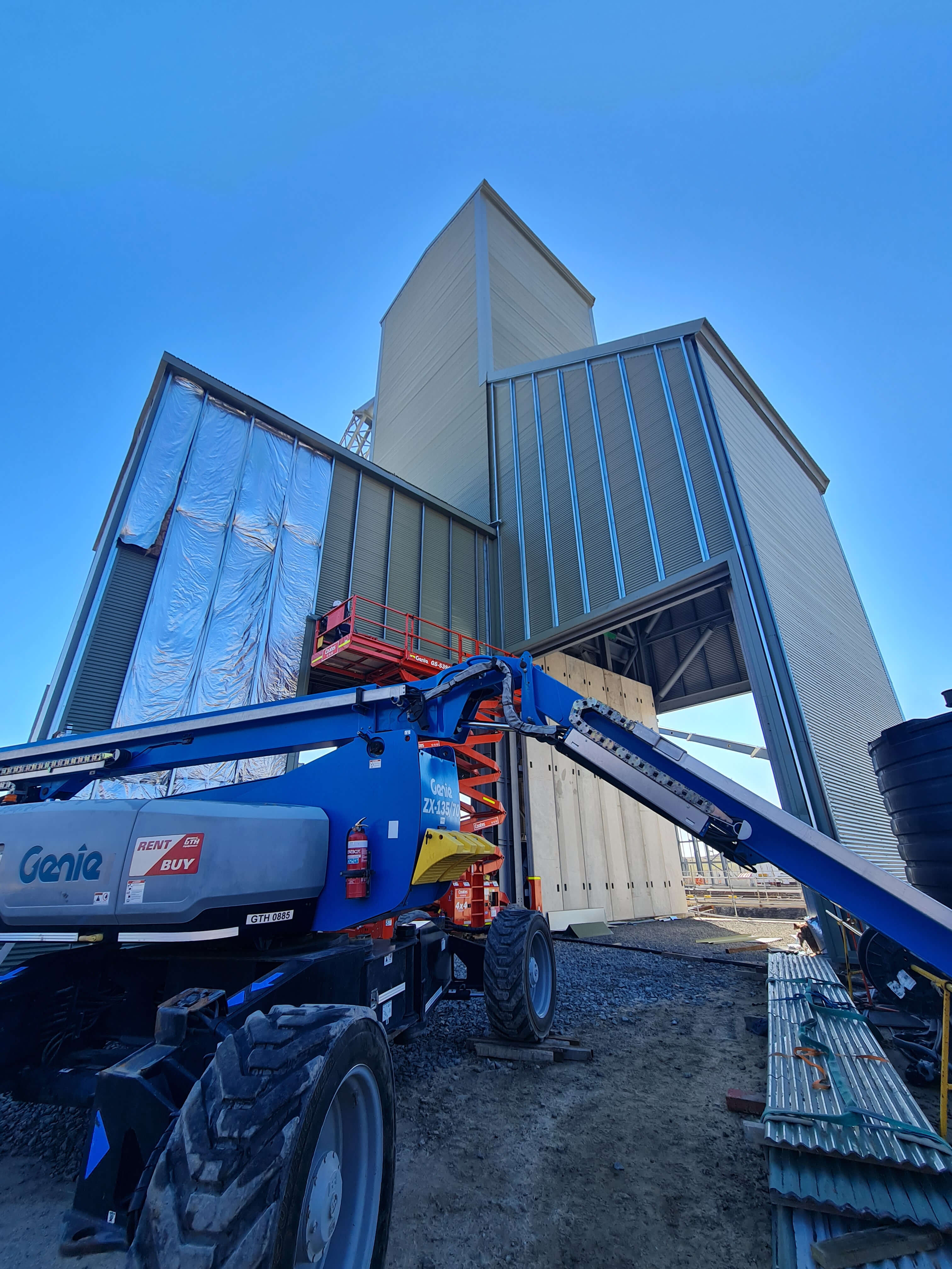2 layered sheeting sound proofing project applying insulation using scissor lifts