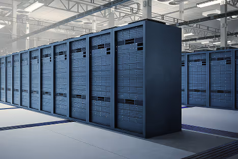 Rows of server racks in a brightly lit, spacious data center.