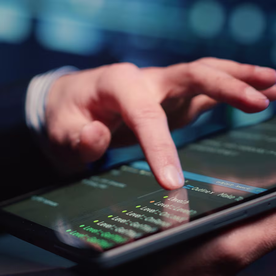 Close-up of a person using a tablet with an outline and levels displayed on the screen.