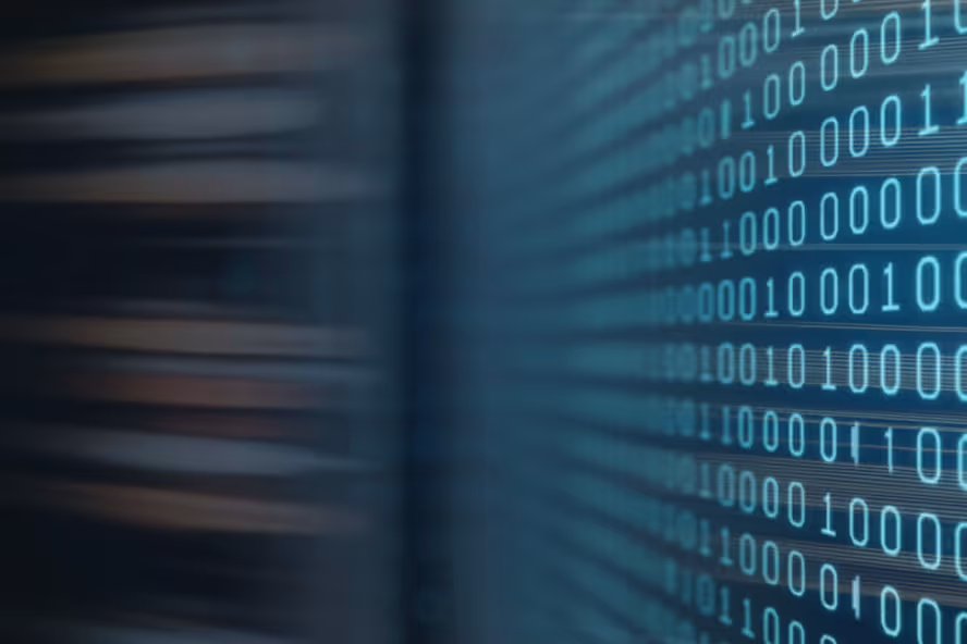 Blurred data center racks on left and binary code digits glowing on a digital screen on right.