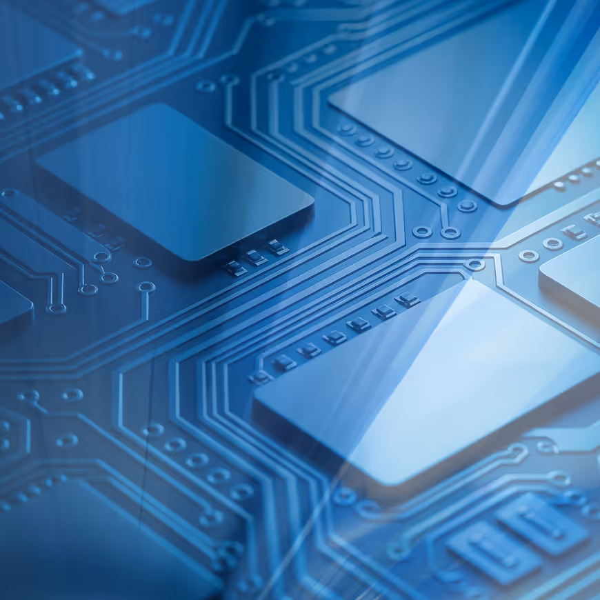 Close-up of a blue-toned computer circuit board with square microchips and connected pathways.
