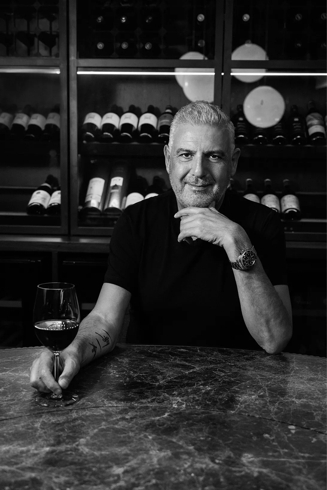 The Seventh Seat host Steve-George Makris with wine glass portrait.