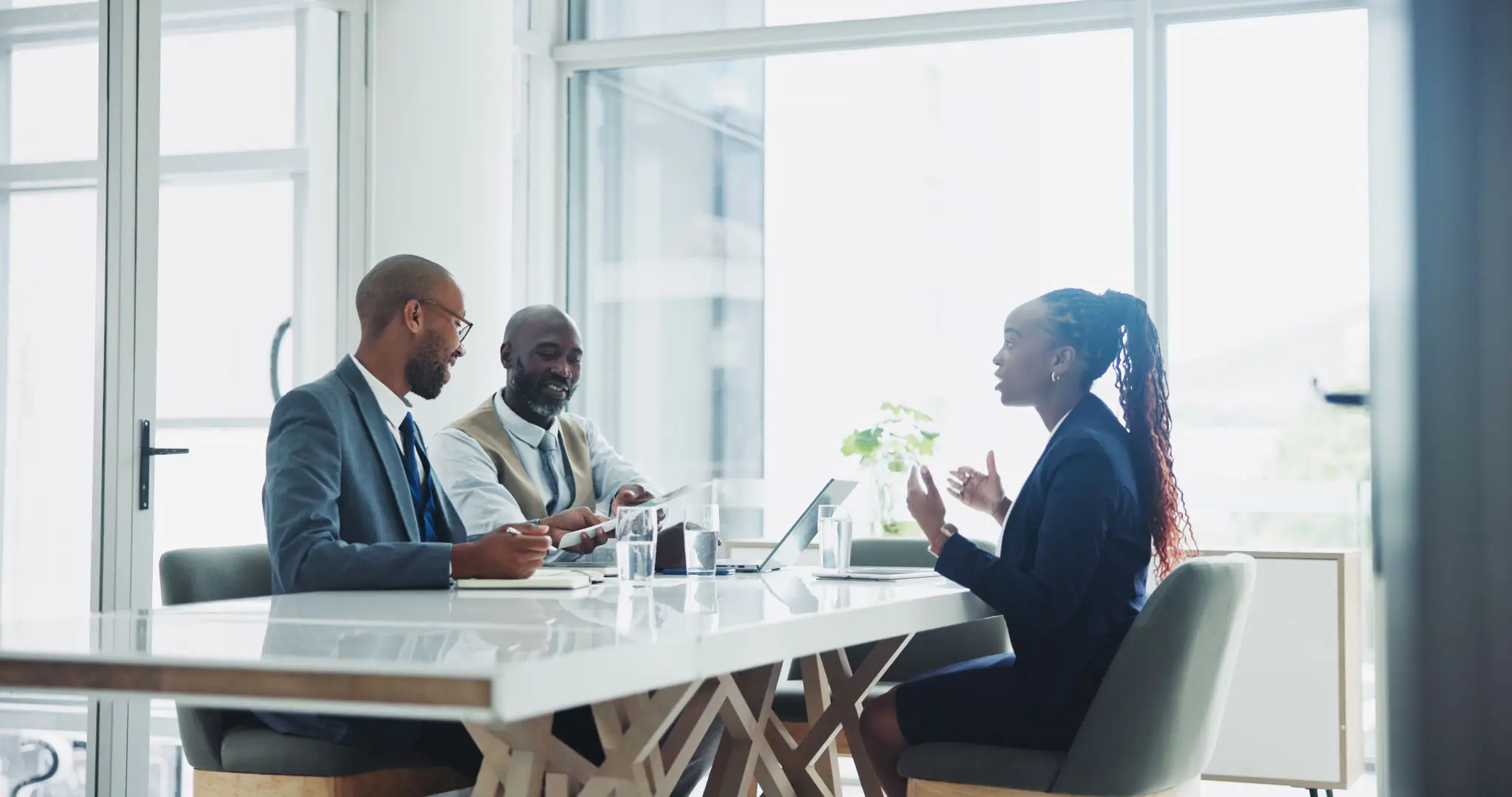Two colleagues reviewing a benefits workflow together in a bright open office