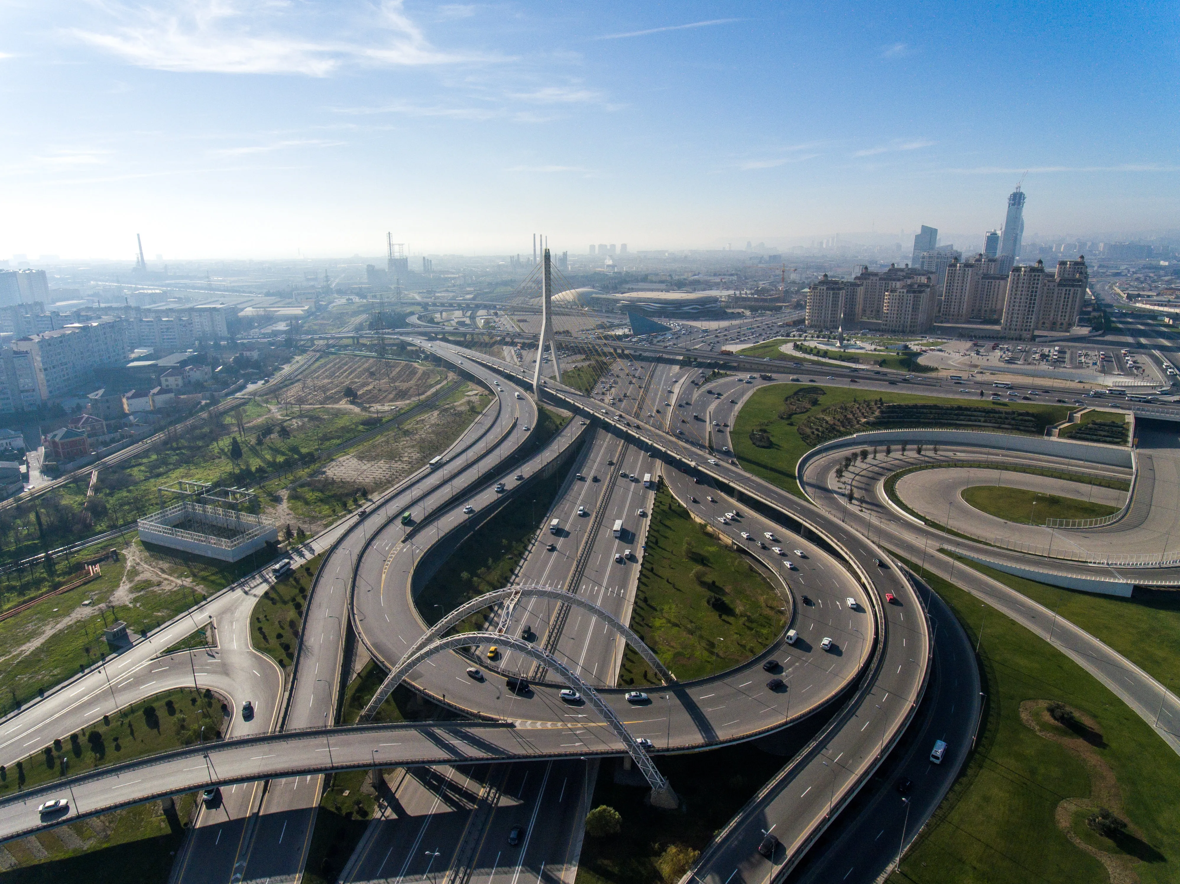 Aerial view of a large highway interchange in a city with multiple lanes and ramps.