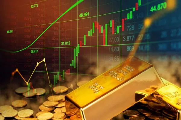 Gold bars and coins with a rising stock chart in the background.
