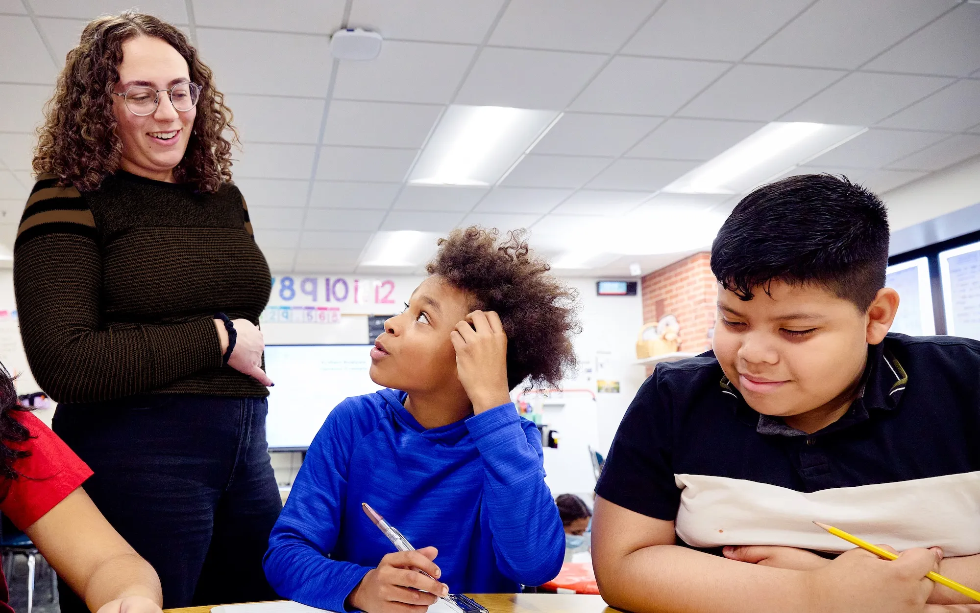 teacher helping student with assignment