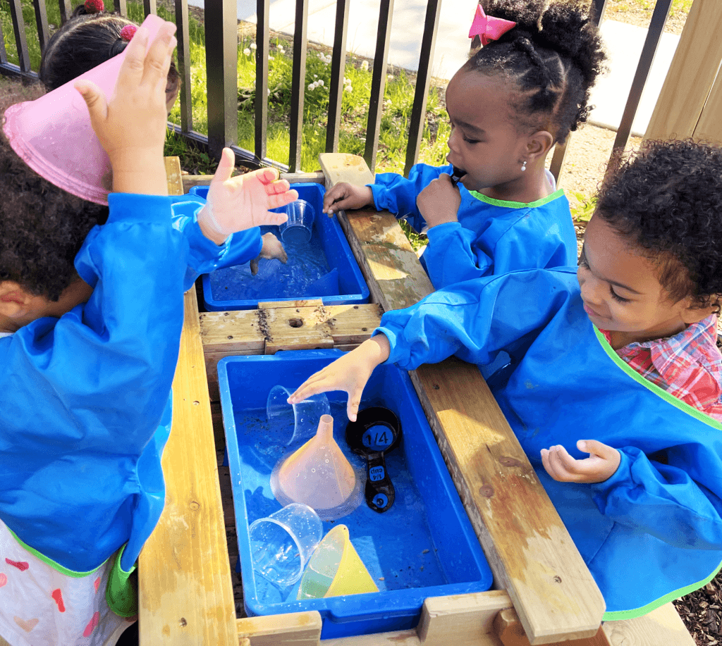 preschool children playing at a water table
