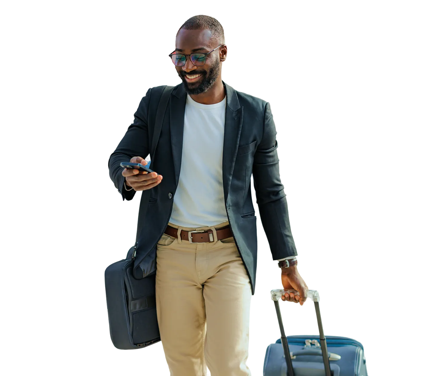 Smiling man walking with luggage and checking his phone