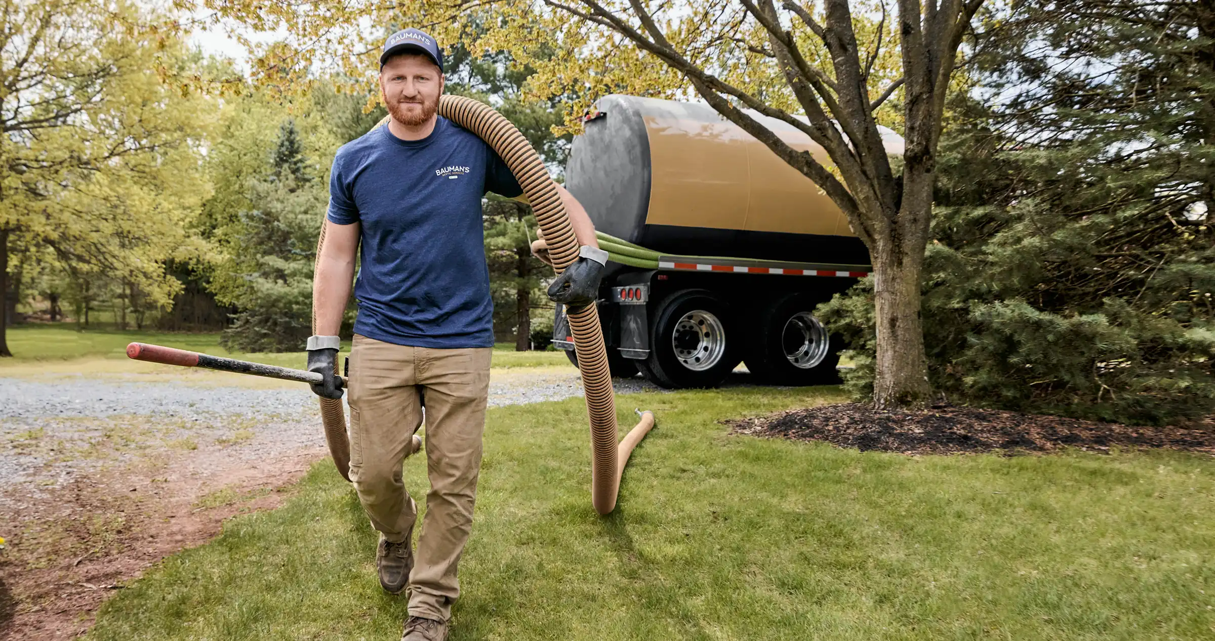 Bauman working on pumping a septic tank