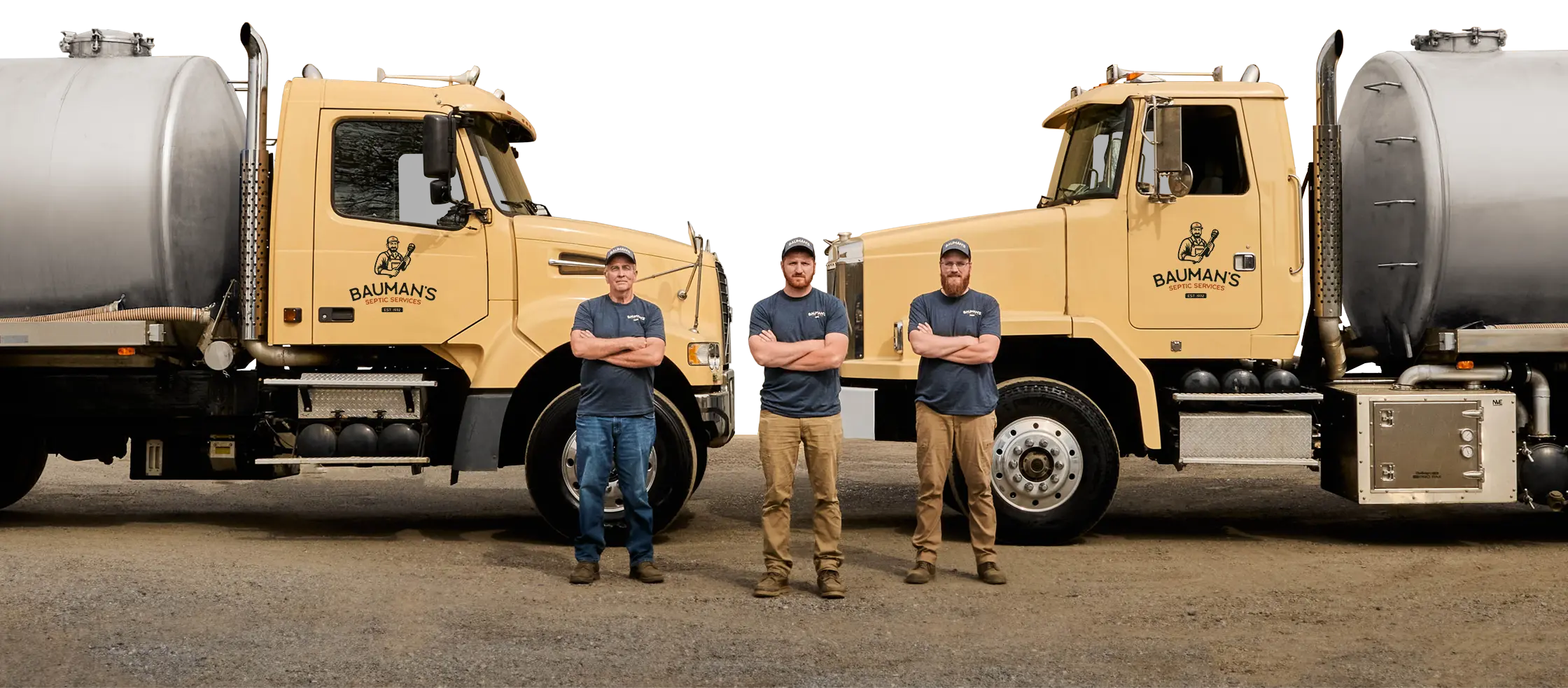 The Bauman Team standing in front of their septic trucks