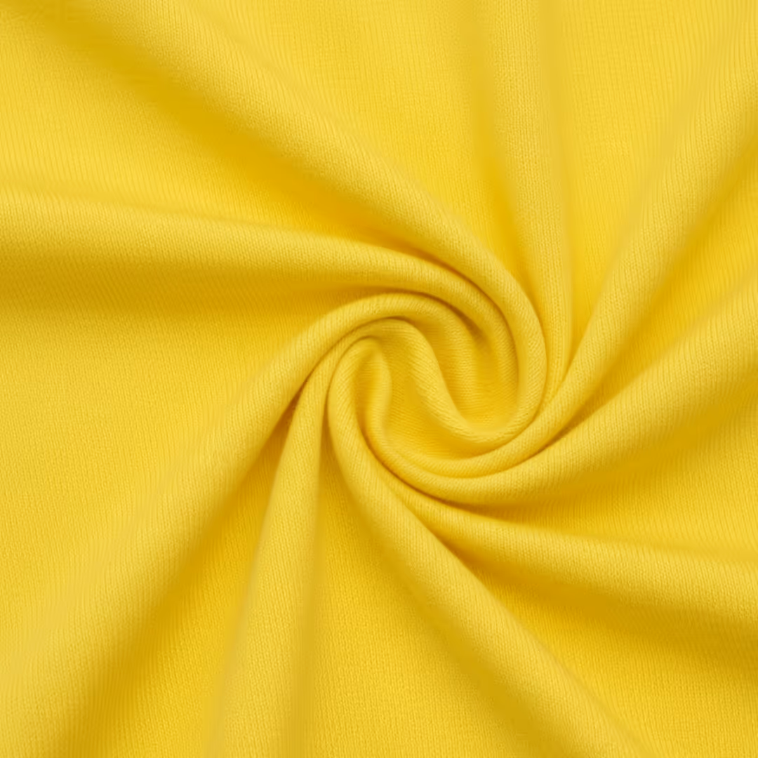 Close-up of bright yellow single knit jersey fabric twisted in the center.