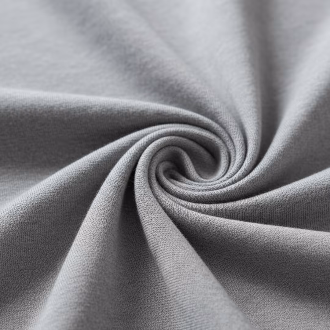 Close-up of soft gray fabric twisted into a spiral shape highlighting its texture.