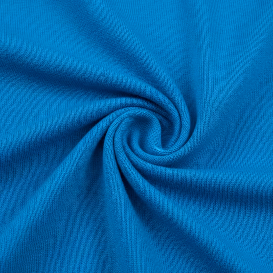 Close-up of blue jersey fabric twisted into a swirl.