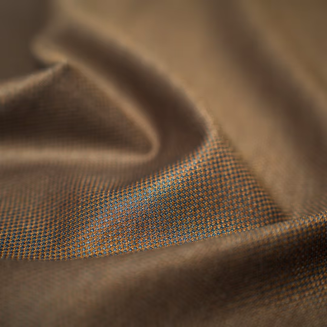 Close-up of a person wearing a blue textured sports jersey with a v-neck collar and short sleeves.