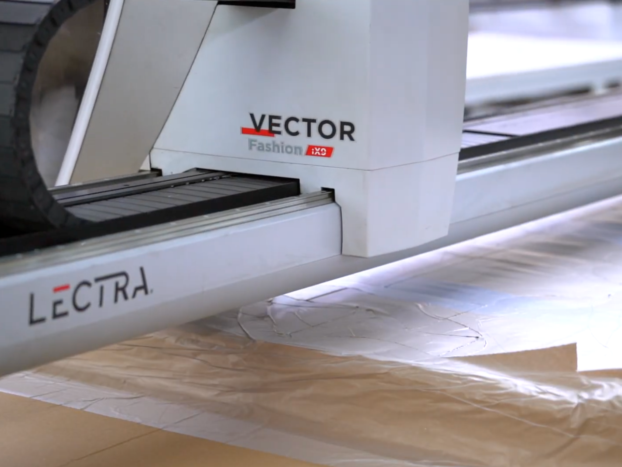 Lectra Vector Fashion cutting machine working on fabric or paper patterns.