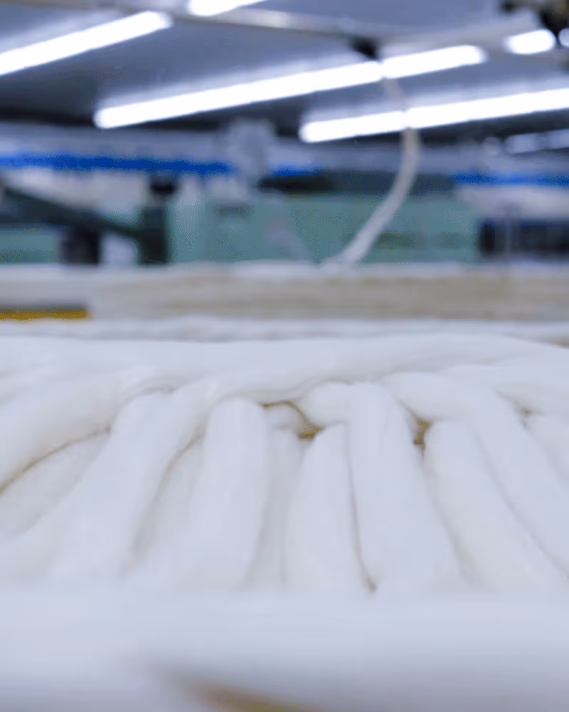 Empty white photo frame with a black rectangular base on a white background.