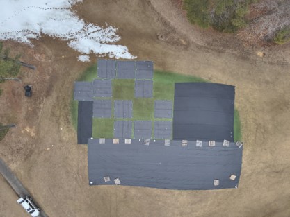Drone view of the trial plots on Green 4 in January 2025, with covered plots under small black covers and no-cover plots as exposed green squares