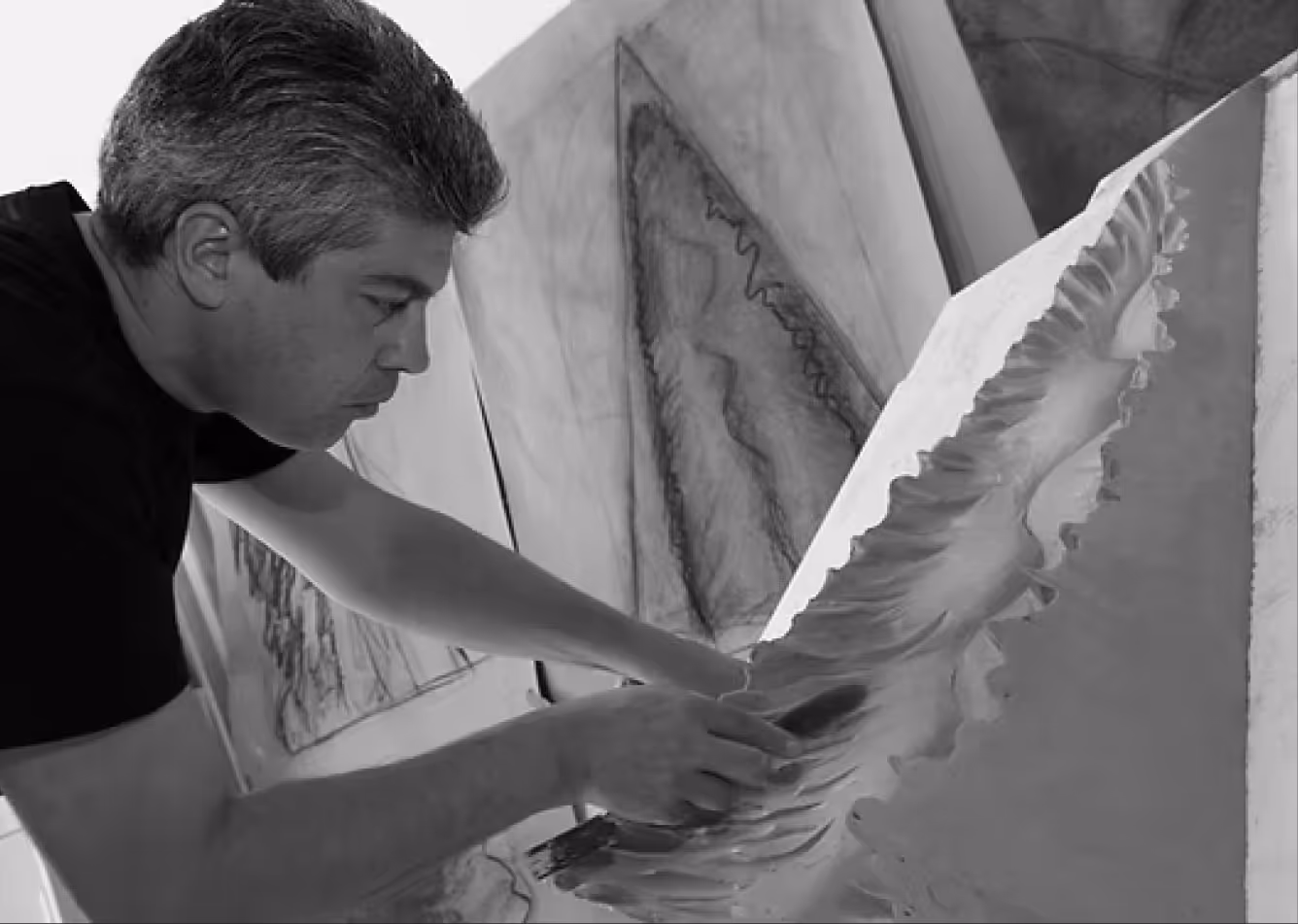 Artist Latchezar Boyadjiev carving or sketching in studio
