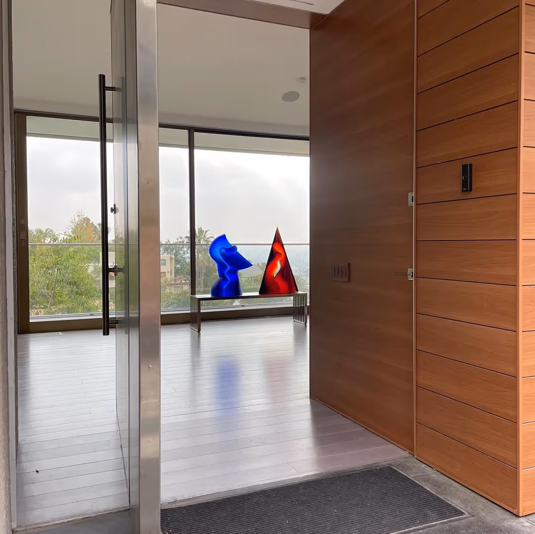 Blue and Red Glass sculptures in a clean open indoor space with zoomed out view