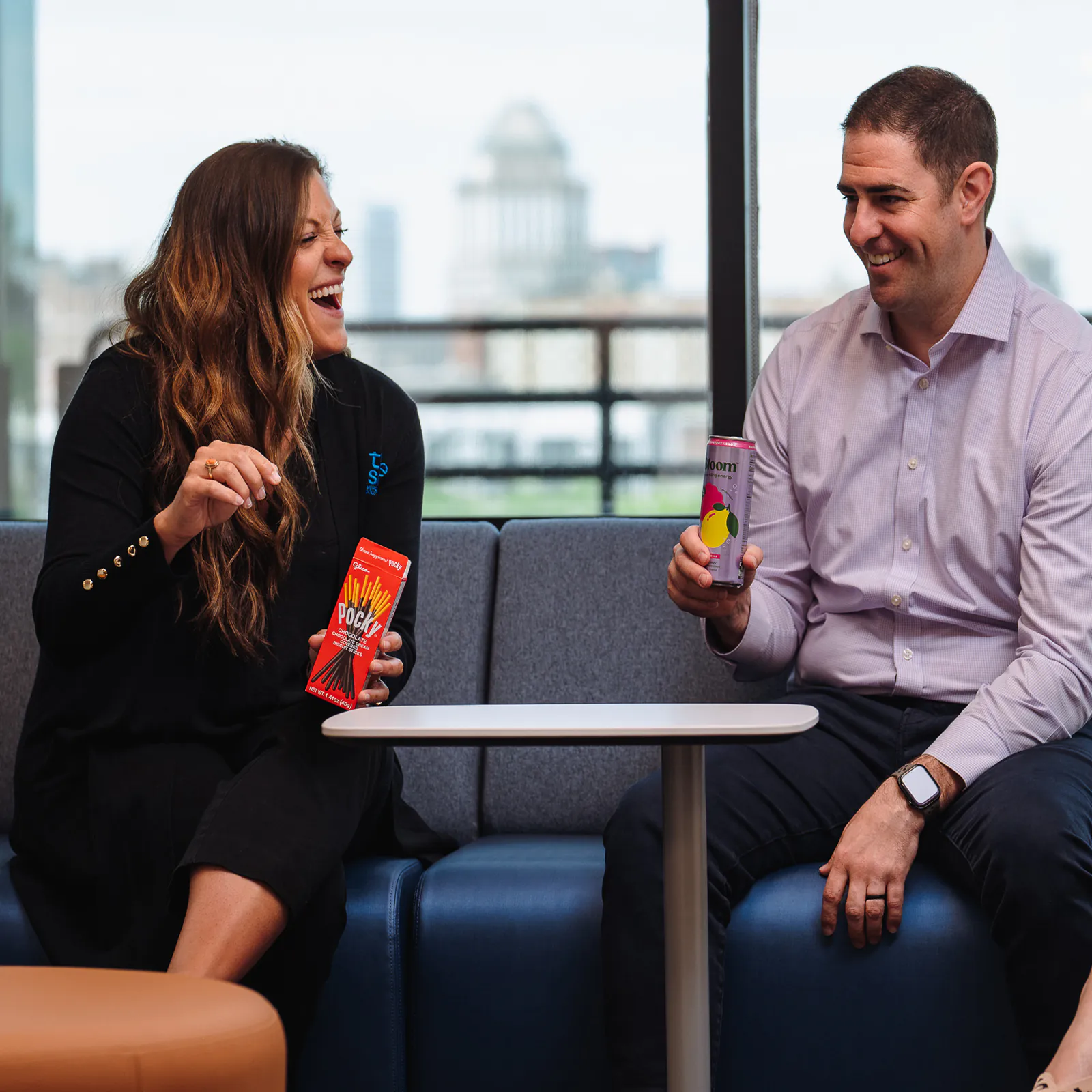 Two employees snacking