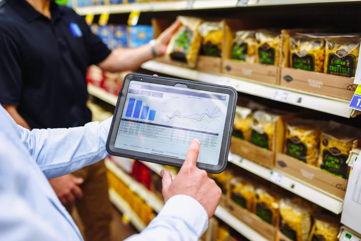 field merchandiser reviewing shelf insights on a tablet