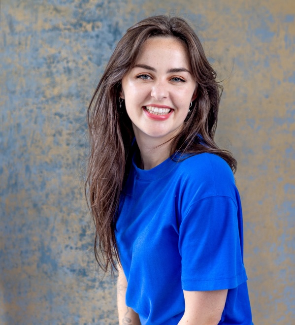 Smiling UX designer in a periwinkle blue shirt