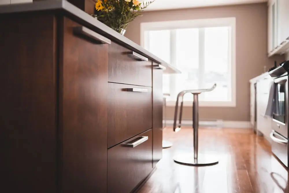 kitchen cabinet brushed nickel pulls modern warm" on Unsplash or Pexels | Alt text: "Kitchen cabinet brushed brass pulls modern renovation Surrey White Rock Langley BC