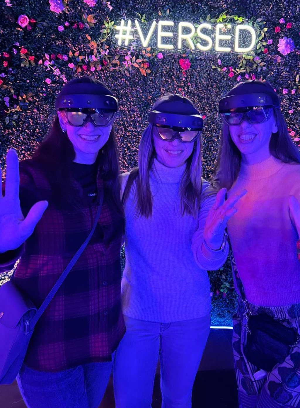 3 ladies wearing AR glasses smiling for a picture