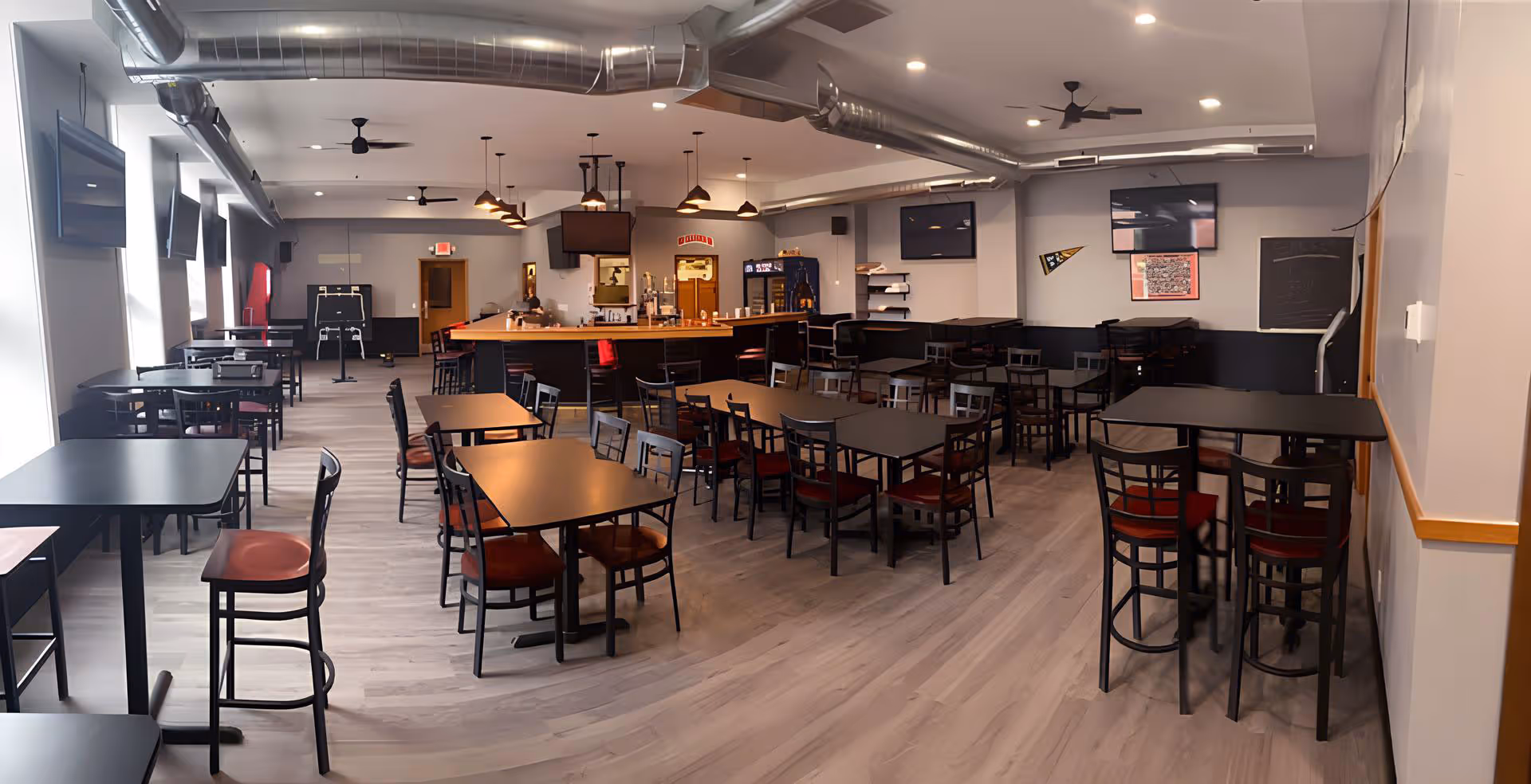 Interior of The Ticket Bar & Grill featuring tables and chairs arranged in the center and sides of the dining area.