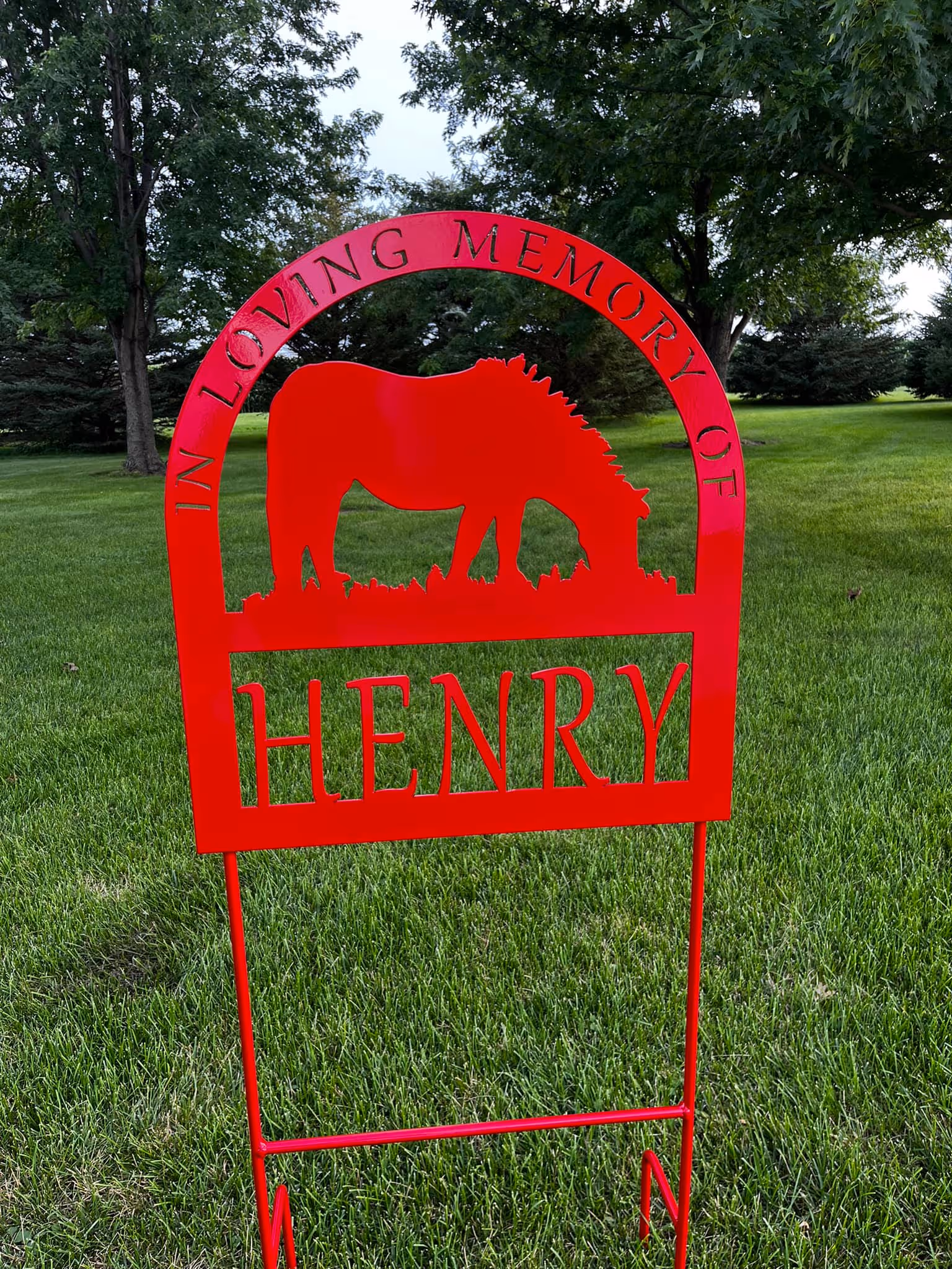 Red metal memorial sign for Henry