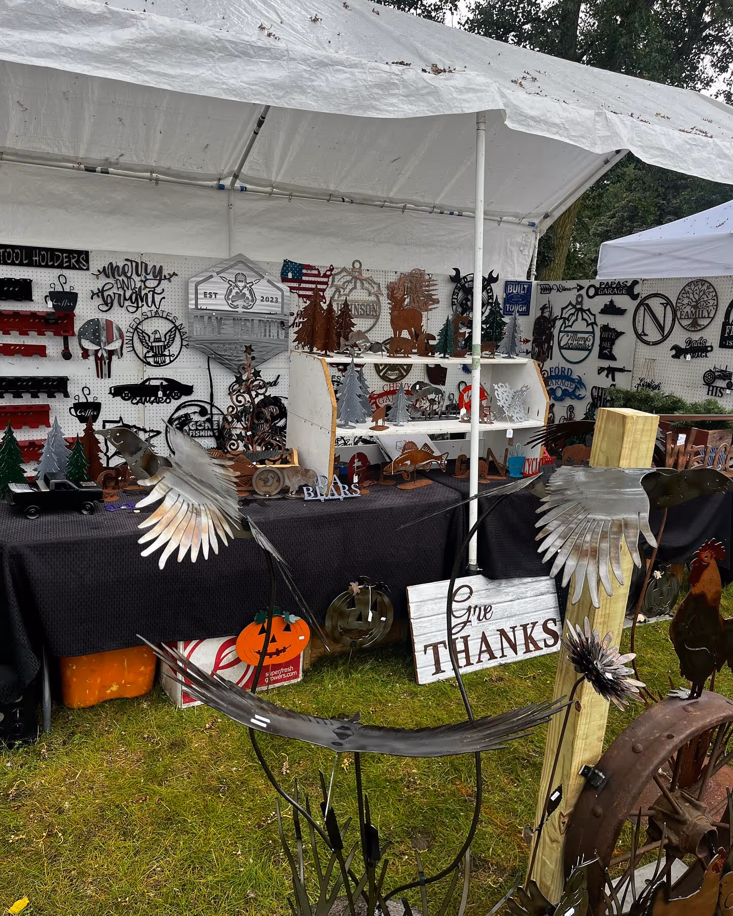 Booth with signs and art for Hasting, MN rivertown days art show