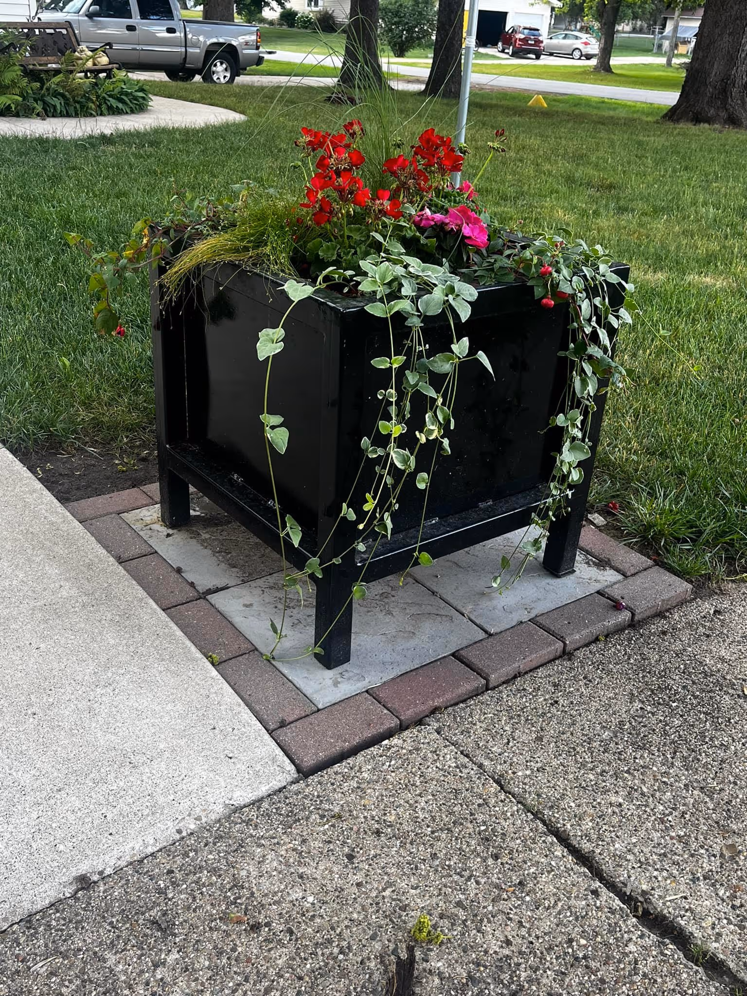 Metal flower planter for sidewalk corner