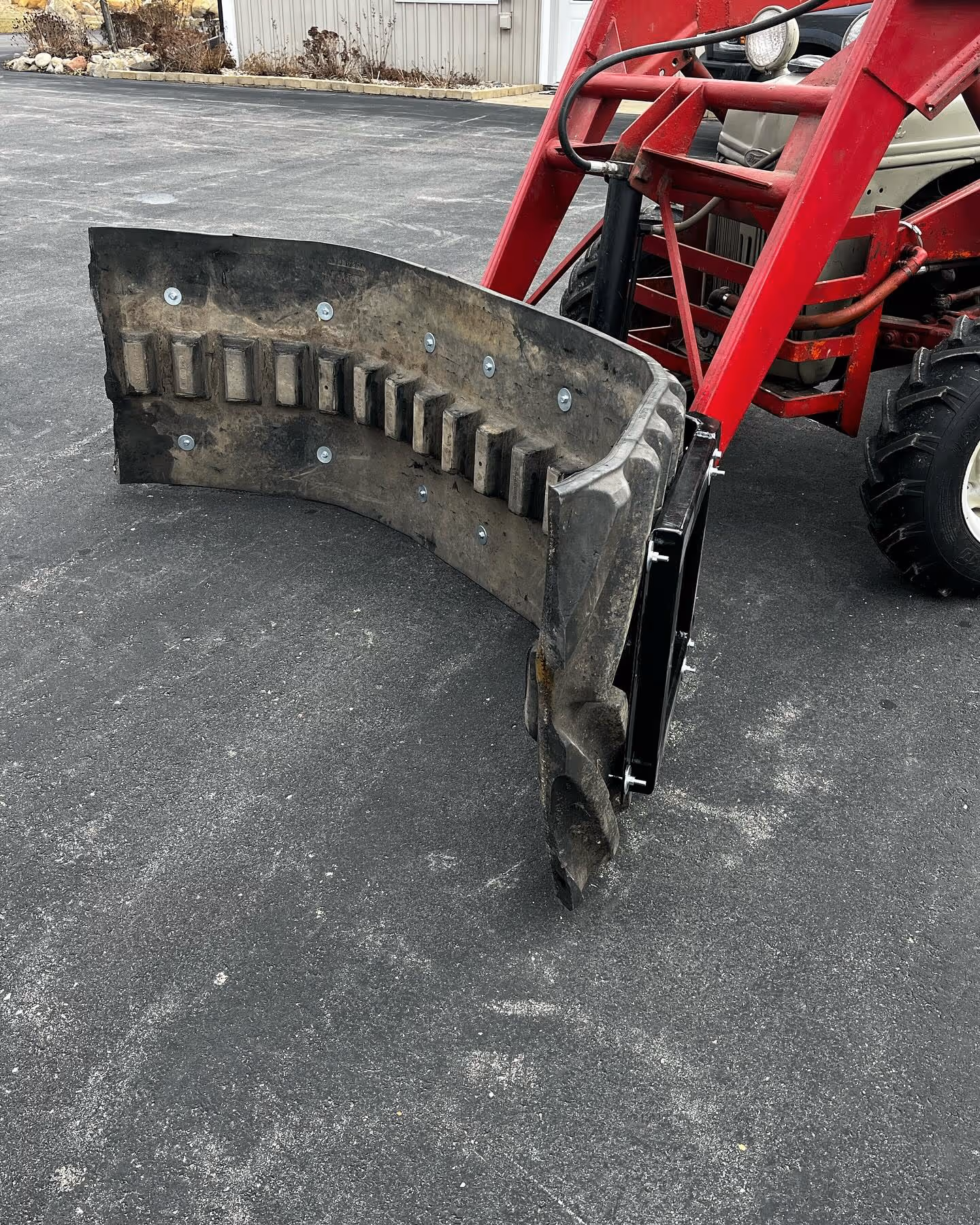 Custom backhoe loader bucket on red backhoe