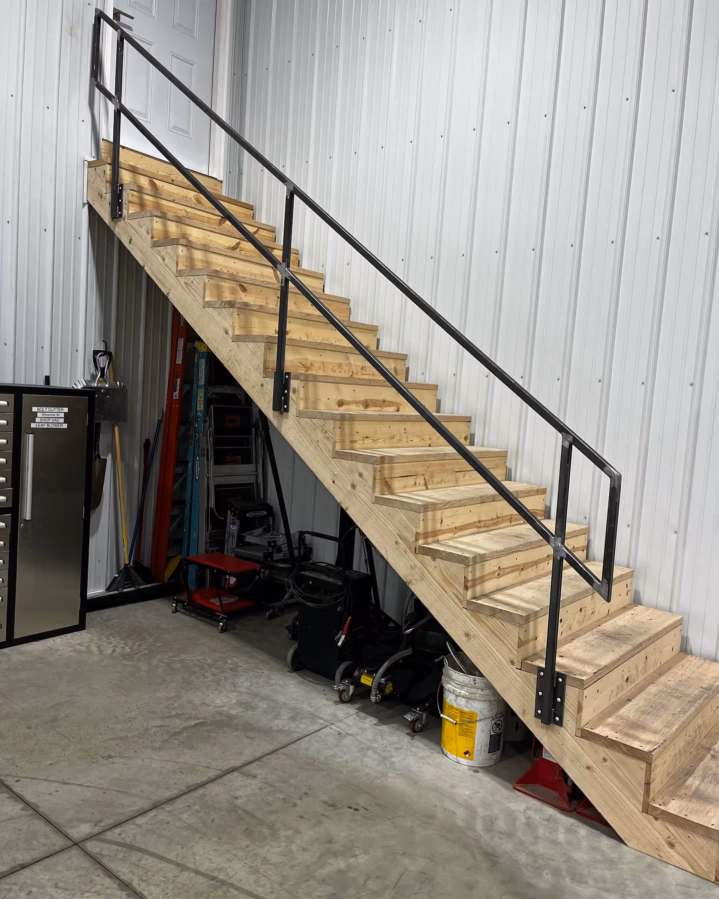 Wood stairs with custom black metal railing