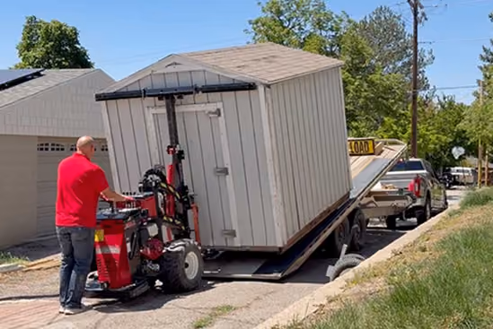 Utah Shed Mover loading a storage shed onto a trailer for site-to-site shed relocation.