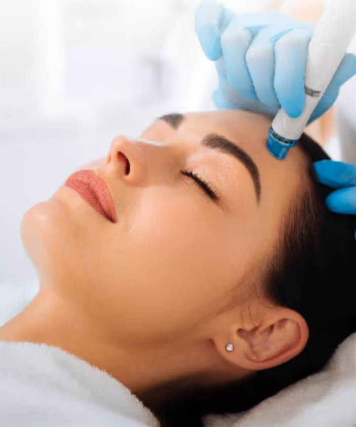 A woman receiving a facial treatment at Natural Beauty by Helen, an independent beauty clinic in Twickenham, London.