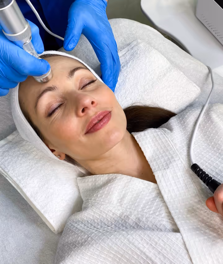 Woman receiving a facial treatment at Natural Beauty by Helen, an independent wellness clinic in Twickenham, London.