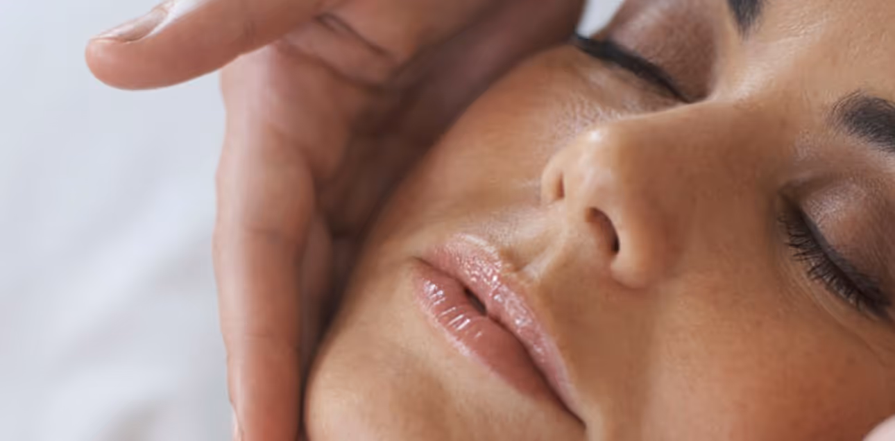 Close-up of a woman receiving a relaxing facial treatment at Natural Beauty by Helen in Twickenham, UK, promoting wellness.