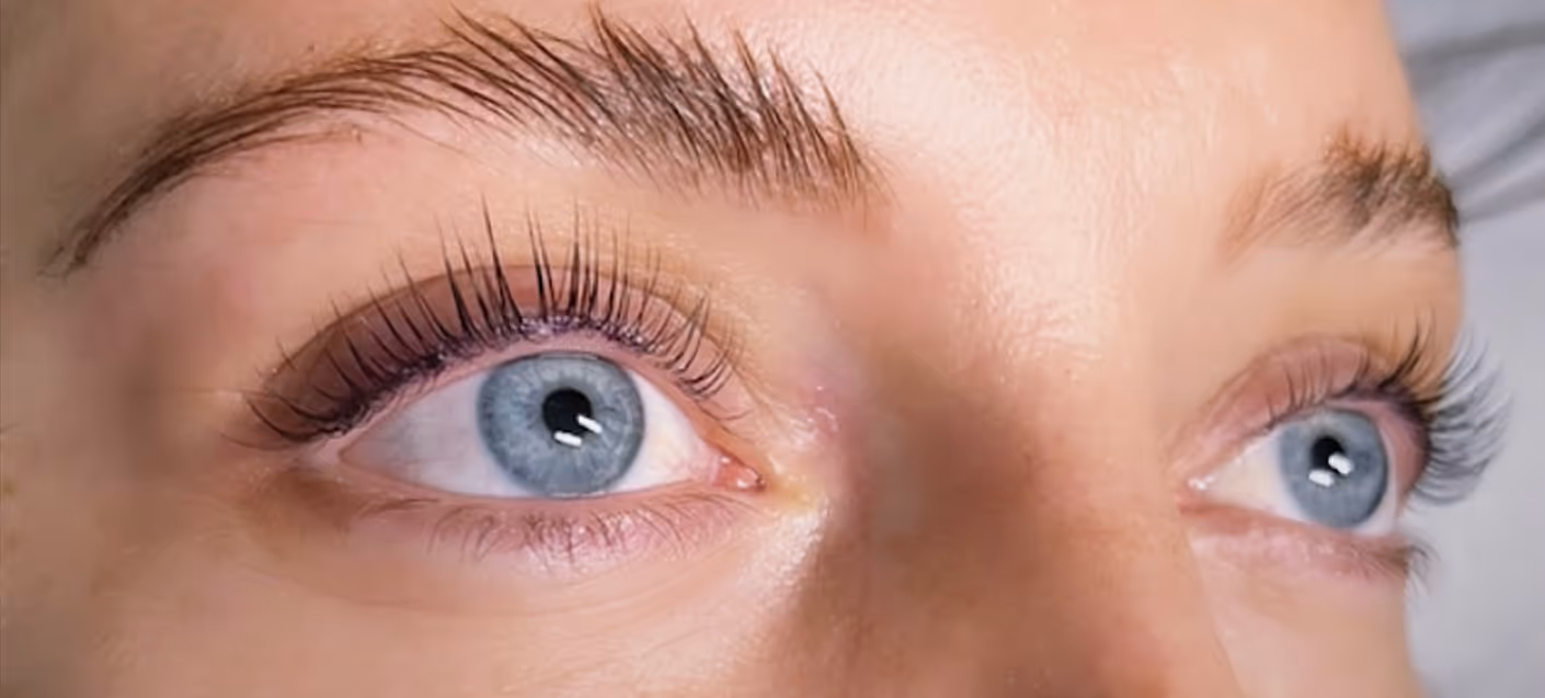 Close-up of beautifully enhanced blue eyes with voluminous lashes, representing the personalized beauty treatments at Natural Beauty by Helen.