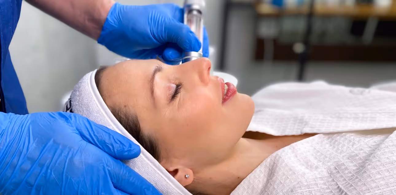 Close-up of a woman receiving a facial treatment in a beauty clinic, showcasing personalized skincare services in Twickenham.