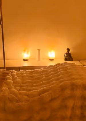 Serene beauty treatment room at Natural Beauty by Helen, featuring candles and soft linens for personalized wellness treatments.