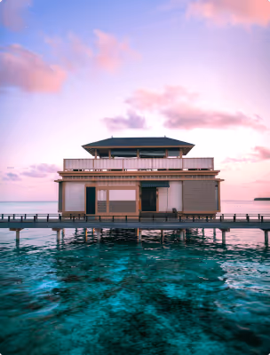 Modern waterfront villa at sunset with crystal-clear ocean views near an ActionLife destination.
