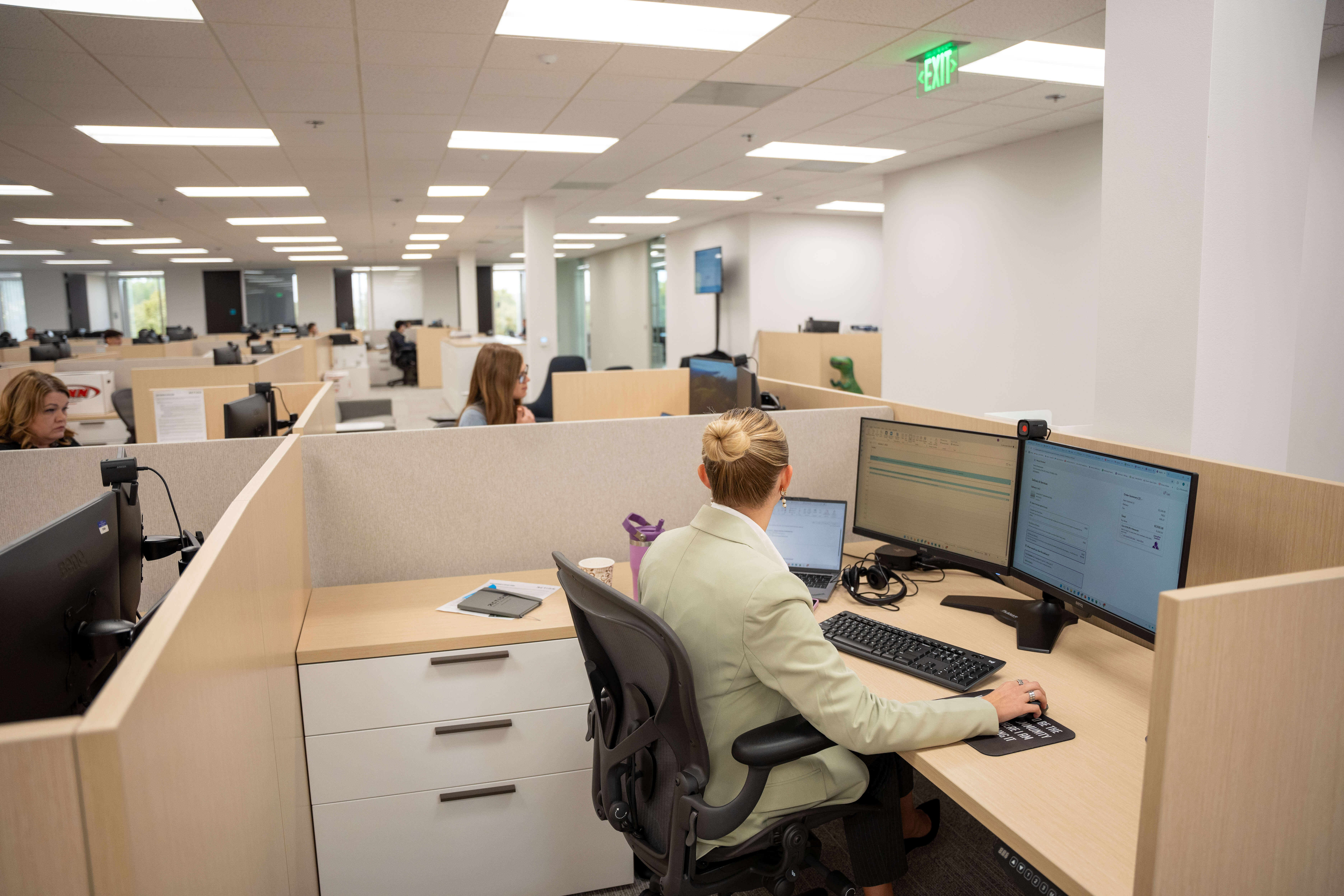 ActionLife employees working at desks in a modern open office space.