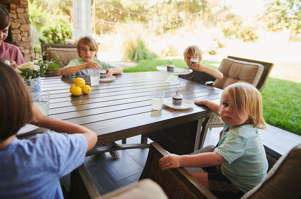 Children enjoying outdoor time at a community table in an ActionLife-managed neighborhood.