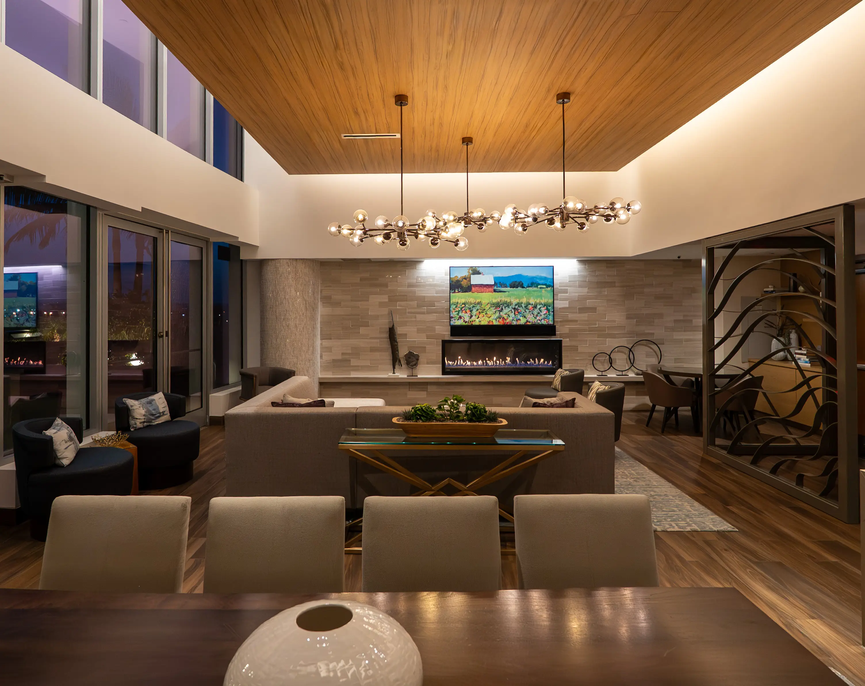 Clubhouse lounge with fireplace and dining area in a community managed by Action Property Management